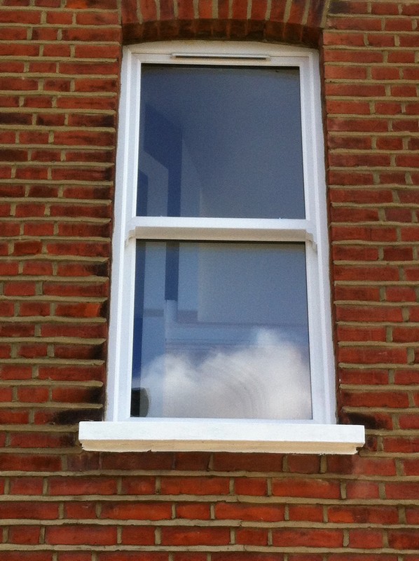 uPVC sash window on Victorian red brick house in Notting Hill